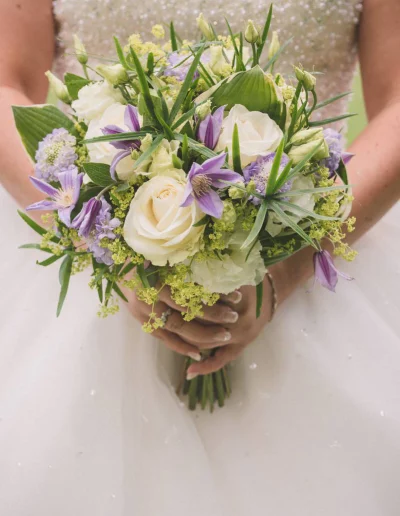 Les détails élégants du mariage capturés par un photographe professionnel en Haute-Savoie : robe de mariée, alliances, fleurs et décorations